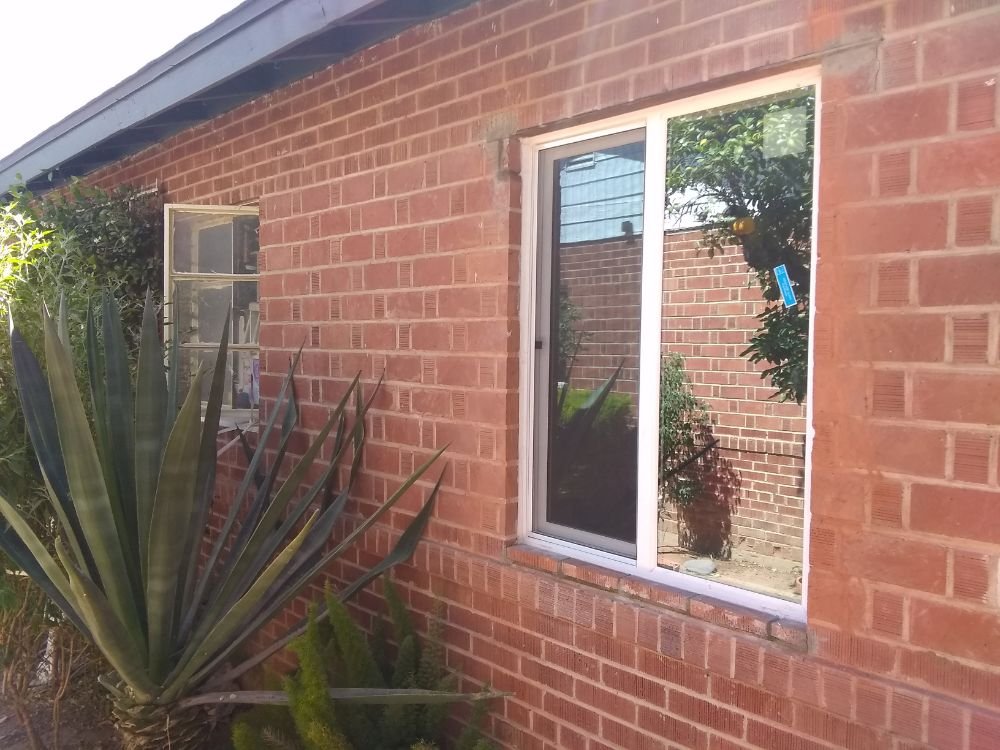 Replacement window installation in a red brick wall